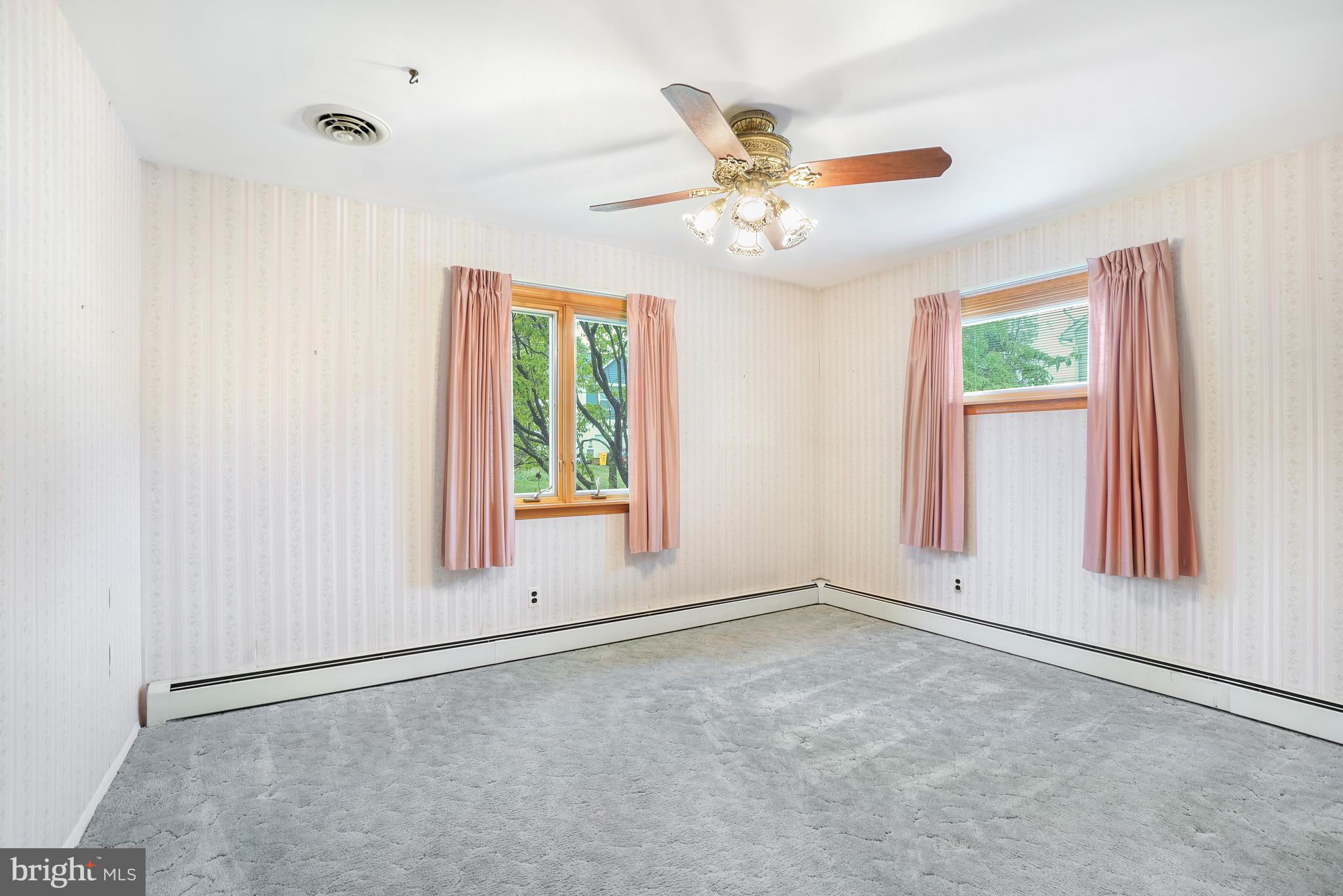 1403 Disney Road Severn, MD 21144 - Photo 17 of 39 an empty room with windows and fan