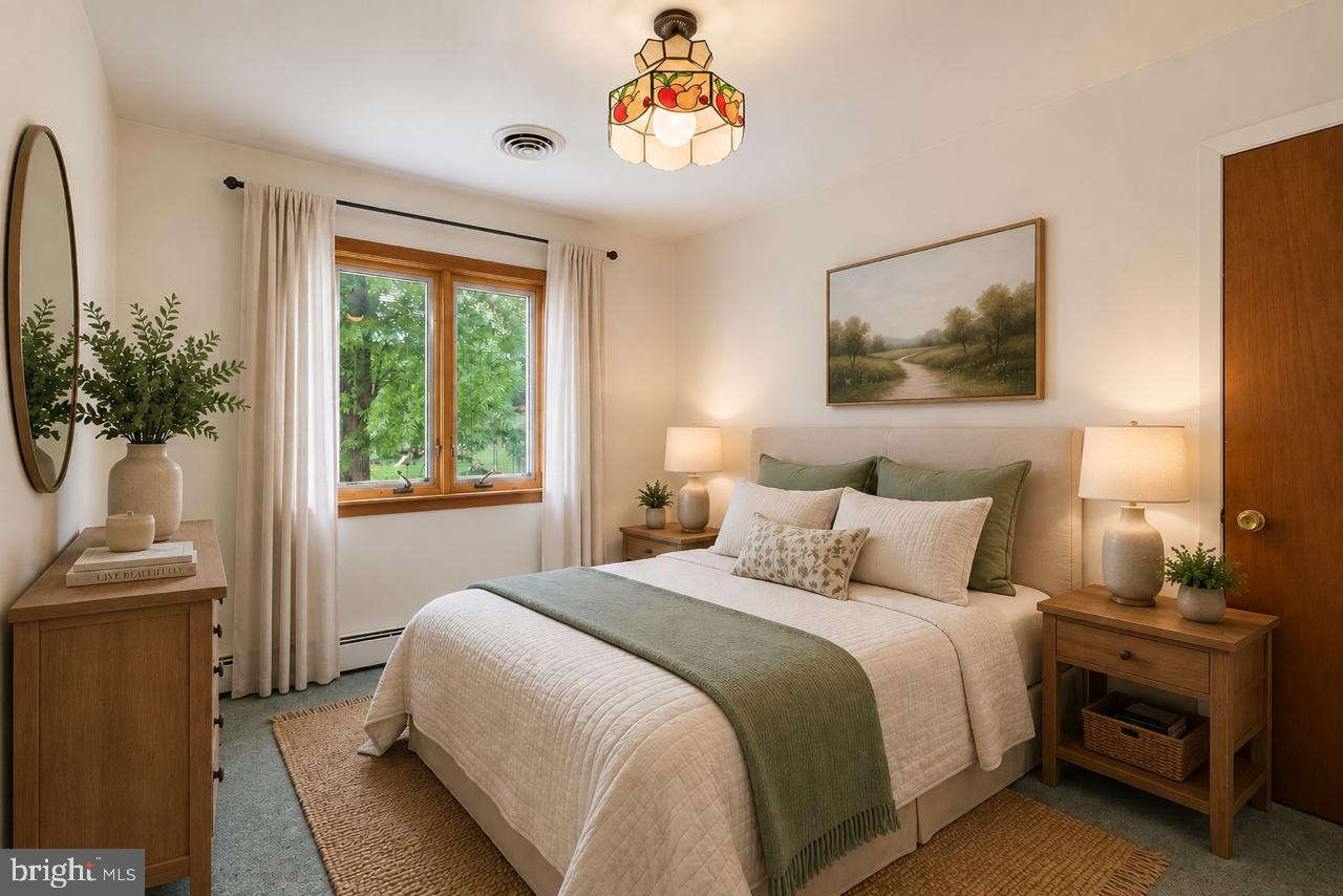 1403 Disney Road Severn, MD 21144 - Photo 21 of 39 a bedroom with a bed and a chandelier