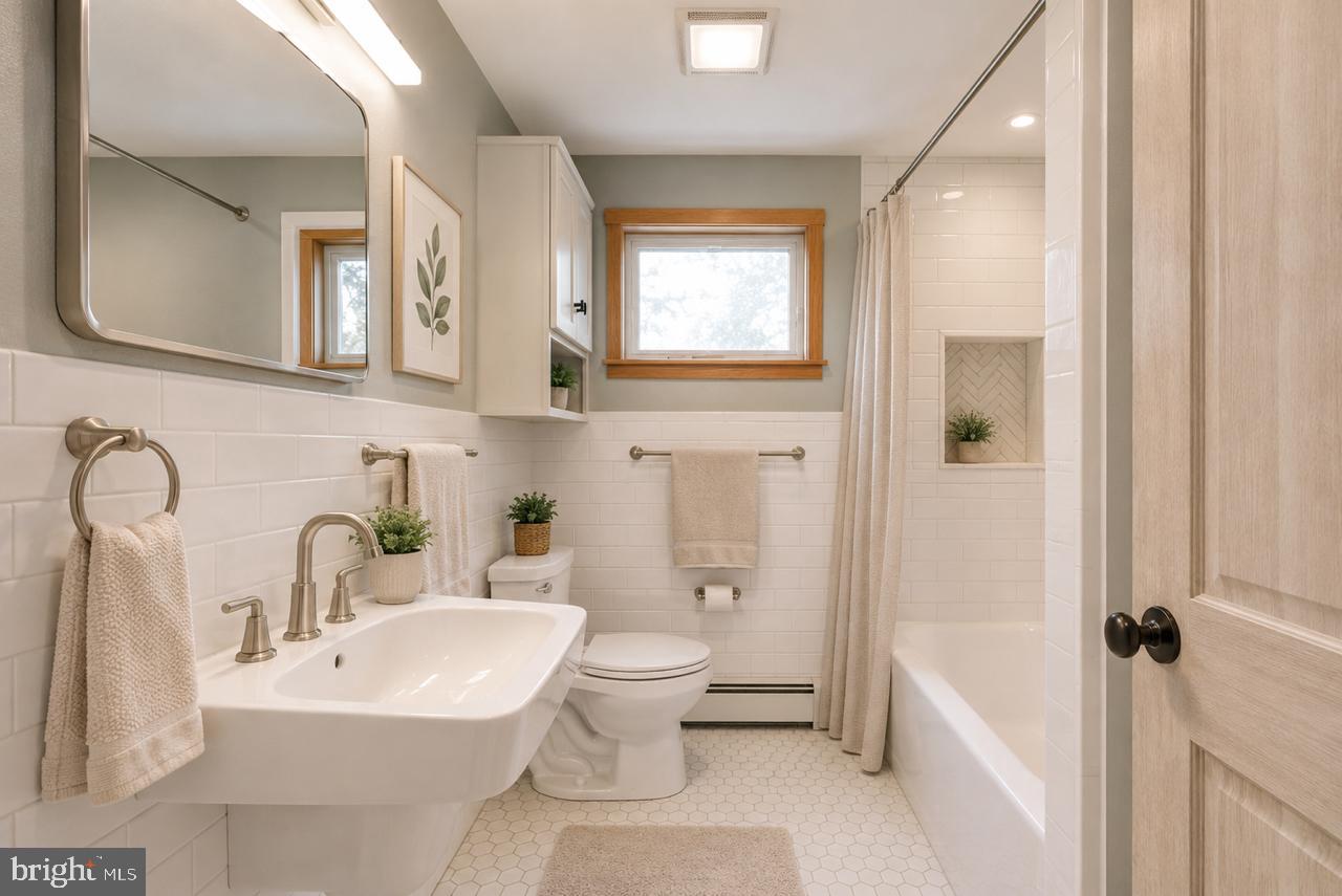 1403 Disney Road Severn, MD 21144 - Photo 25 of 39 a bathroom with a sink toilet and shower