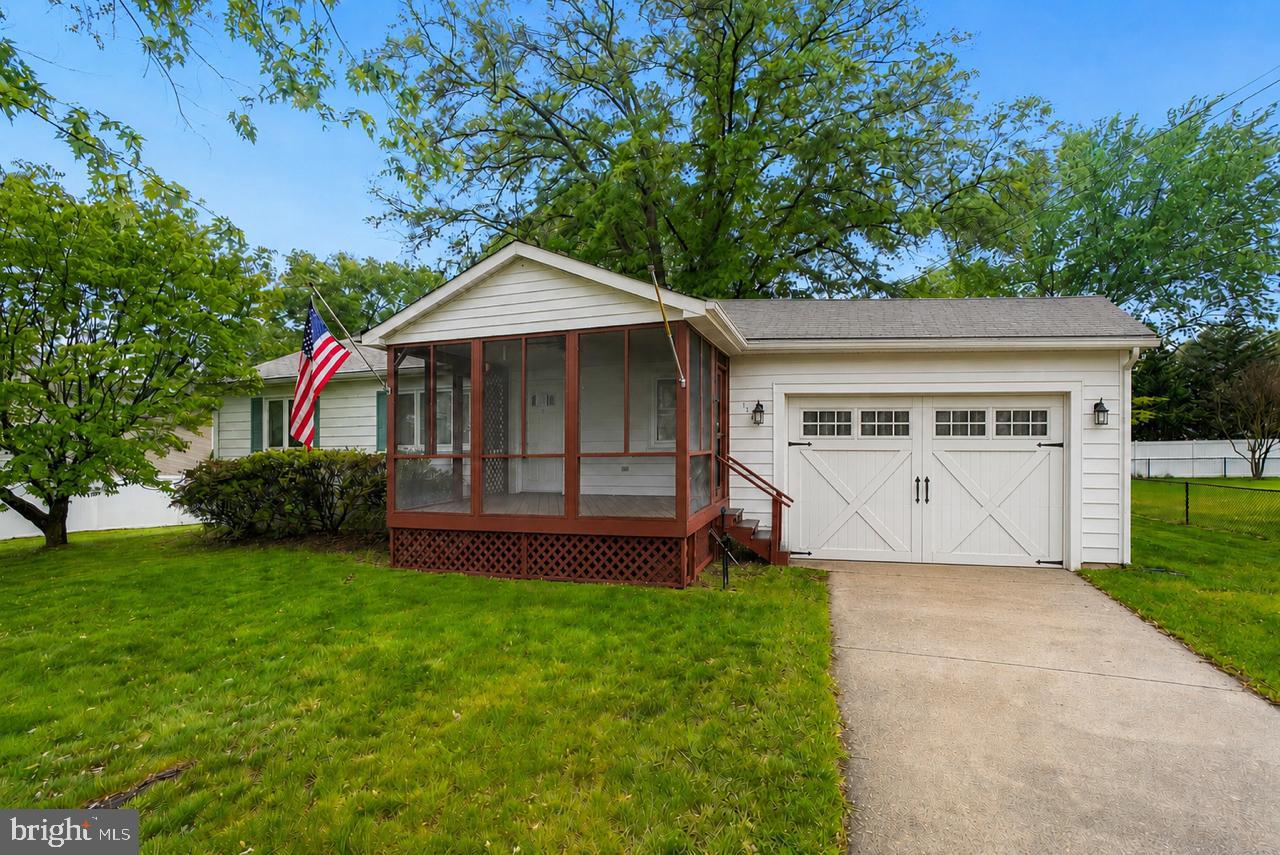1403 Disney Road Severn, MD 21144 - Photo 39 of 39 a front view of a house with a yard and garage