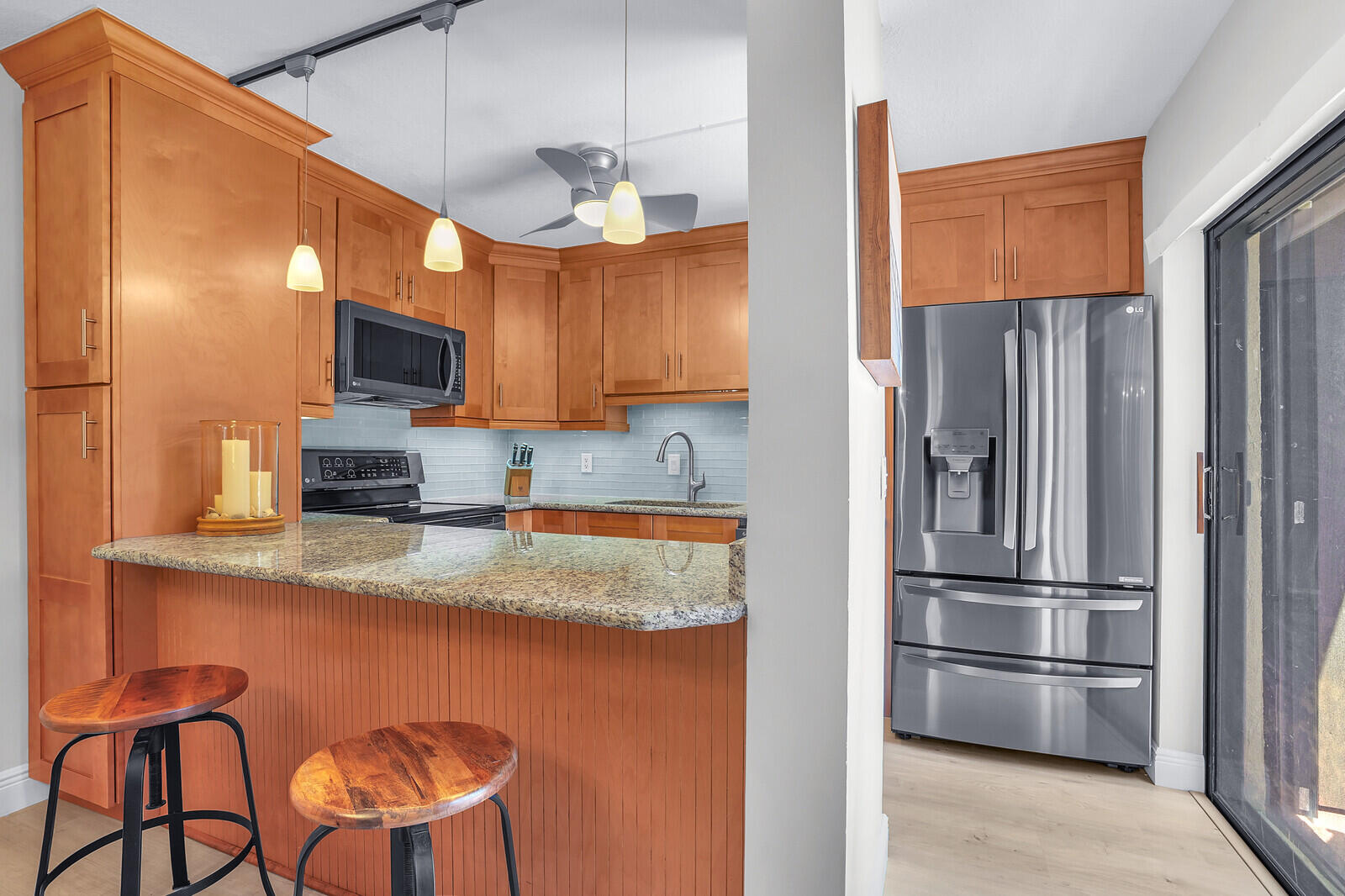 825 Center Street, Unit 14A Jupiter, FL 33458 - Photo 11 of 57 a kitchen with stainless steel appliances granite countertop a refrigerator a stove a sink and a microwave