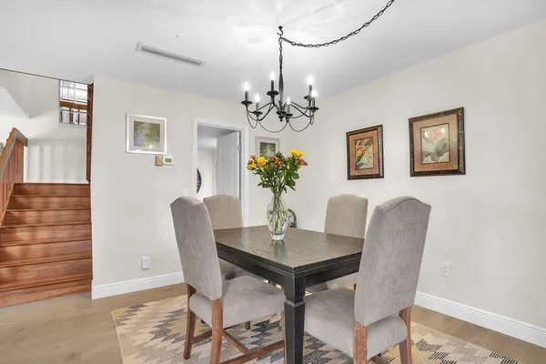 a dining room with furniture and chandelier