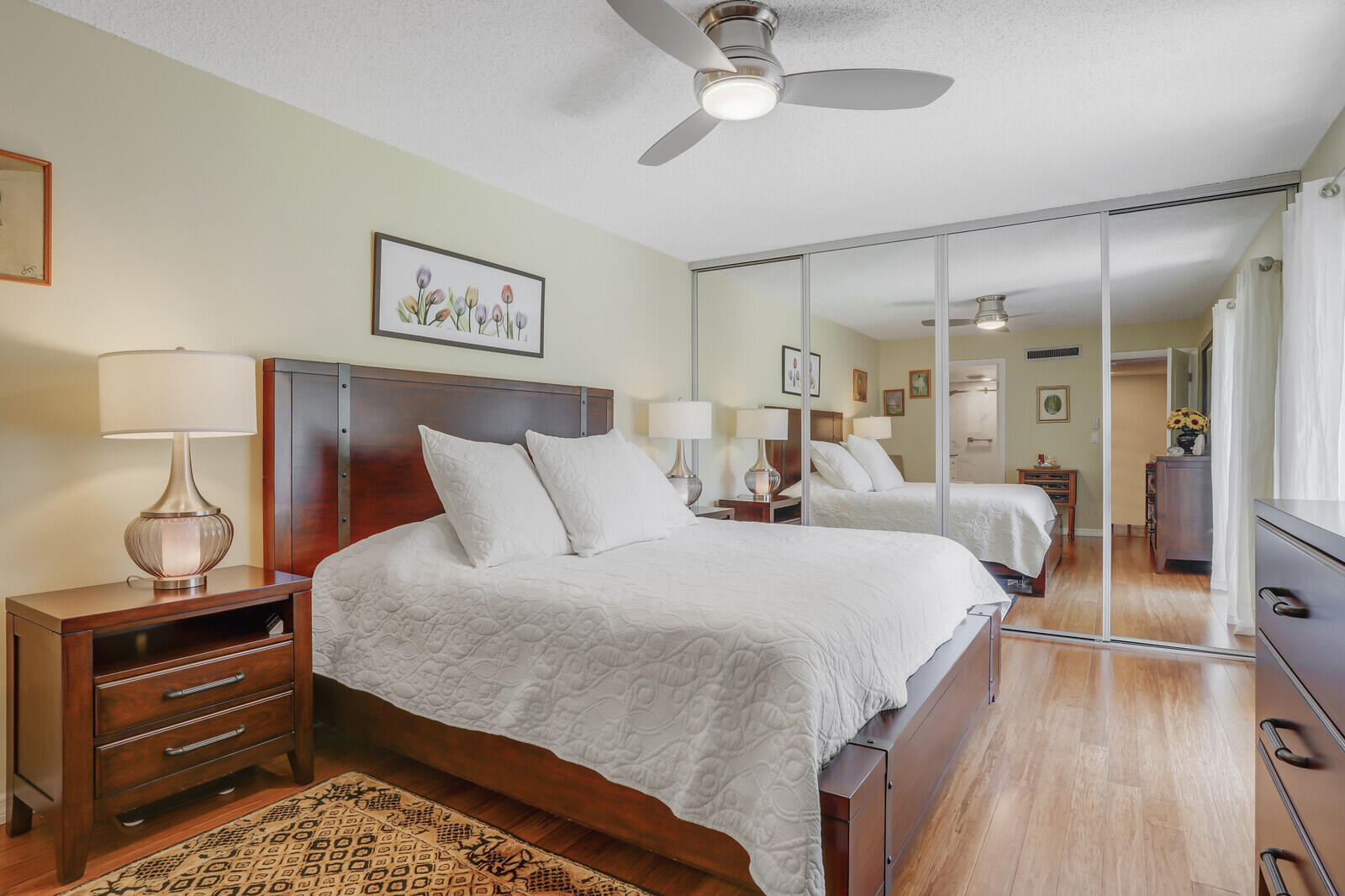 825 Center Street, Unit 14A Jupiter, FL 33458 - Photo 20 of 57 a bedroom with bed and wooden floor