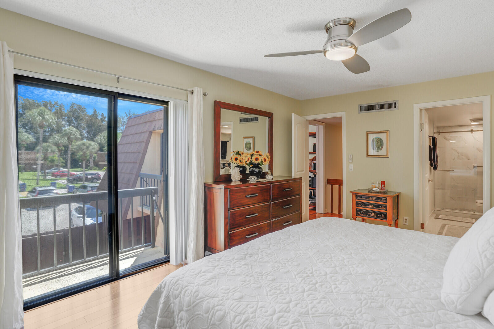825 Center Street, Unit 14A Jupiter, FL 33458 - Photo 22 of 57 a bedroom with a large bed and a dresser