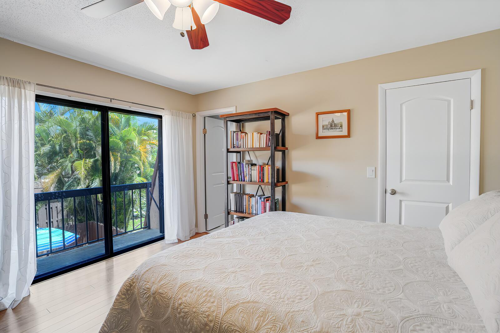 825 Center Street, Unit 14A Jupiter, FL 33458 - Photo 26 of 57 a bedroom with a large bed and a large window