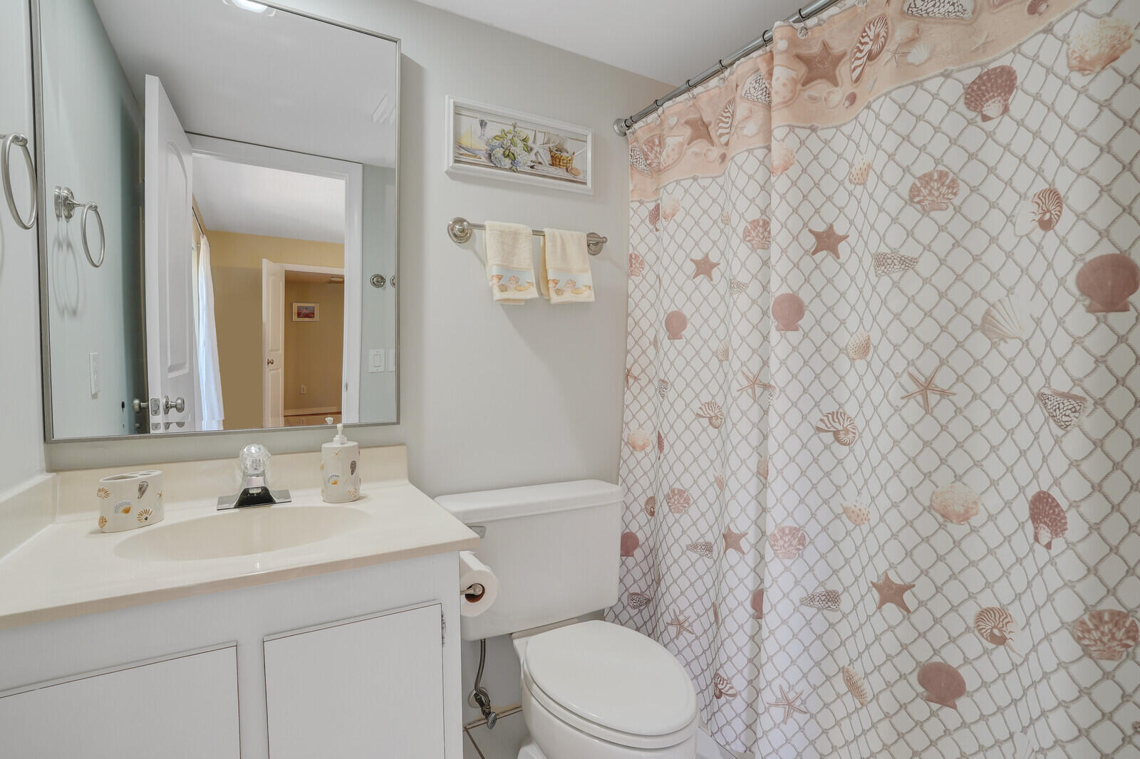 825 Center Street, Unit 14A Jupiter, FL 33458 - Photo 28 of 57 a bathroom with a toilet sink and mirror