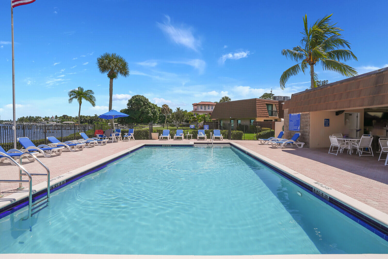 825 Center Street, Unit 14A Jupiter, FL 33458 - Photo 38 of 57 a view of a swimming pool and lounge chairs
