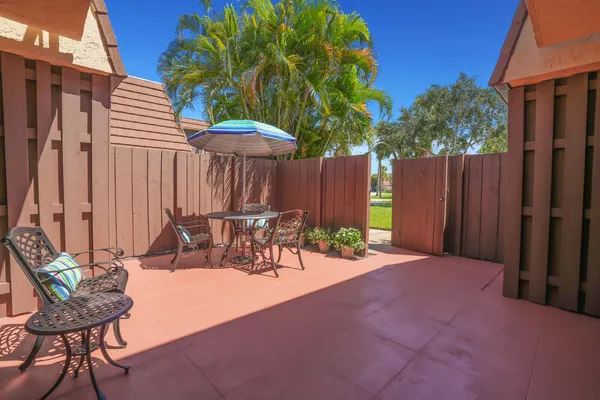 a view of a chairs and table in patio
