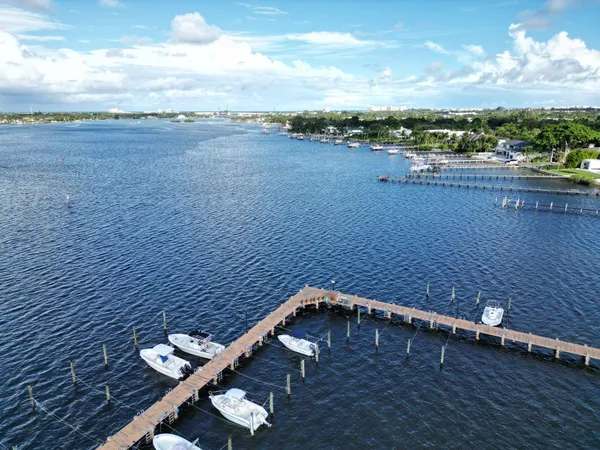 a front view of a house with a yard and lake view
