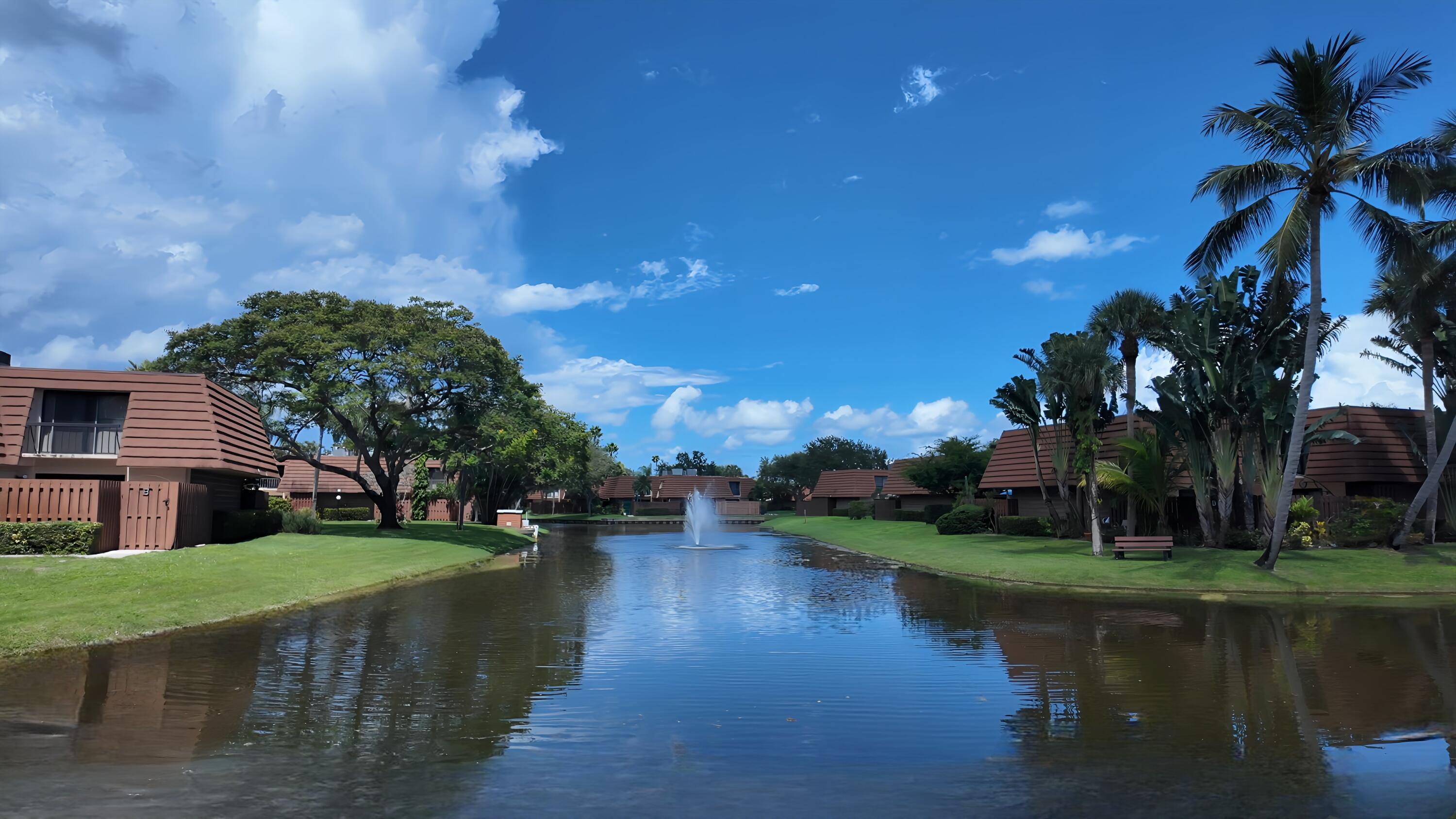 825 Center Street, Unit 14A Jupiter, FL 33458 - Photo 47 of 57 a view of a lake with a house in the background