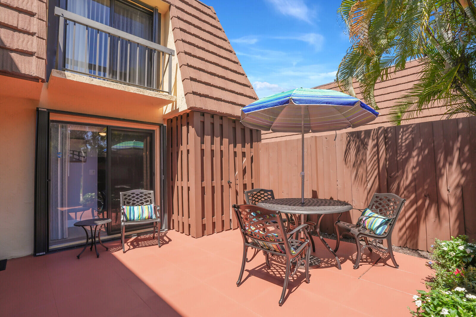 825 Center Street, Unit 14A Jupiter, FL 33458 - Photo 5 of 57 a patio with a table and chairs