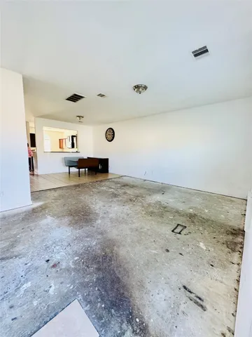 a view of a livingroom with furniture and refrigerator