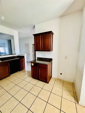 a kitchen with stainless steel appliances granite countertop a stove a microwave and a refrigerator