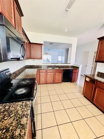 a kitchen with a sink a stove and a refrigerator