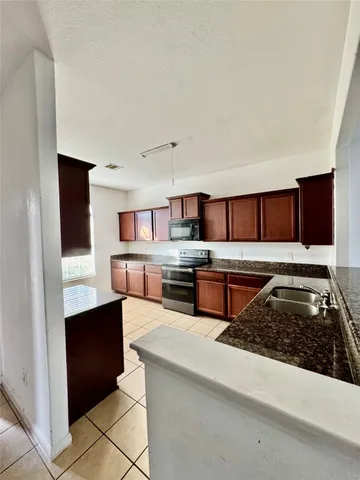 a kitchen with stainless steel appliances granite countertop a stove and a sink