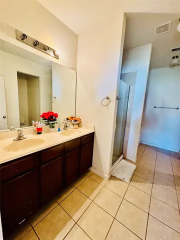 a bathroom with a sink vanity and a mirror
