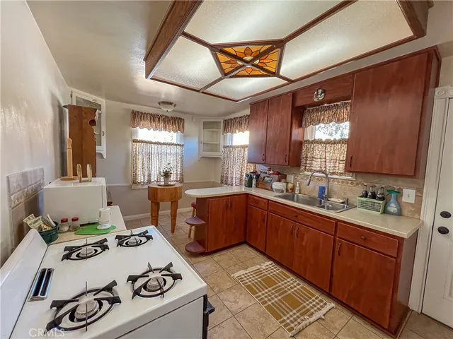 a kitchen with a stove a sink and a refrigerator