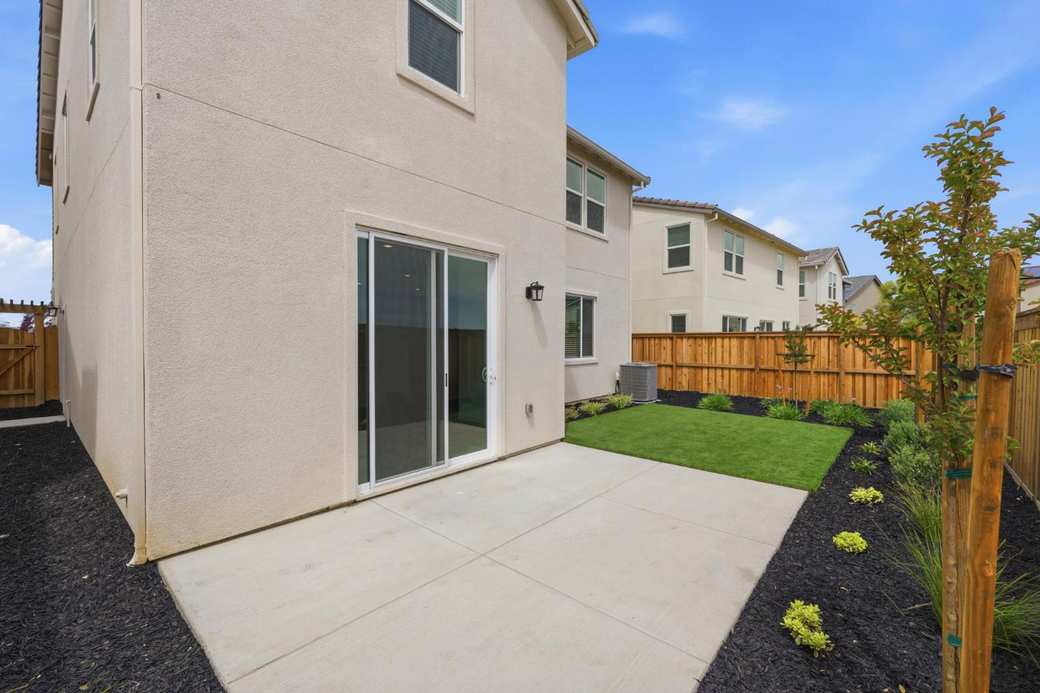 1270 Ribiolo Lane Mountain House, CA 95391 - Photo 12 of 13 a view of a white house next to a yard with big trees