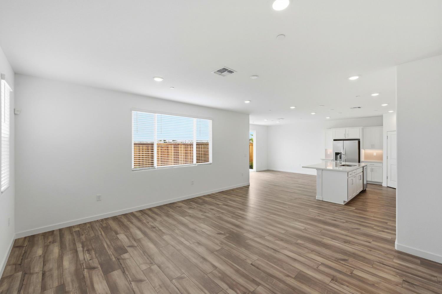 1270 Ribiolo Lane Mountain House, CA 95391 - Photo 4 of 13 a view of an empty room with wooden floor and a window