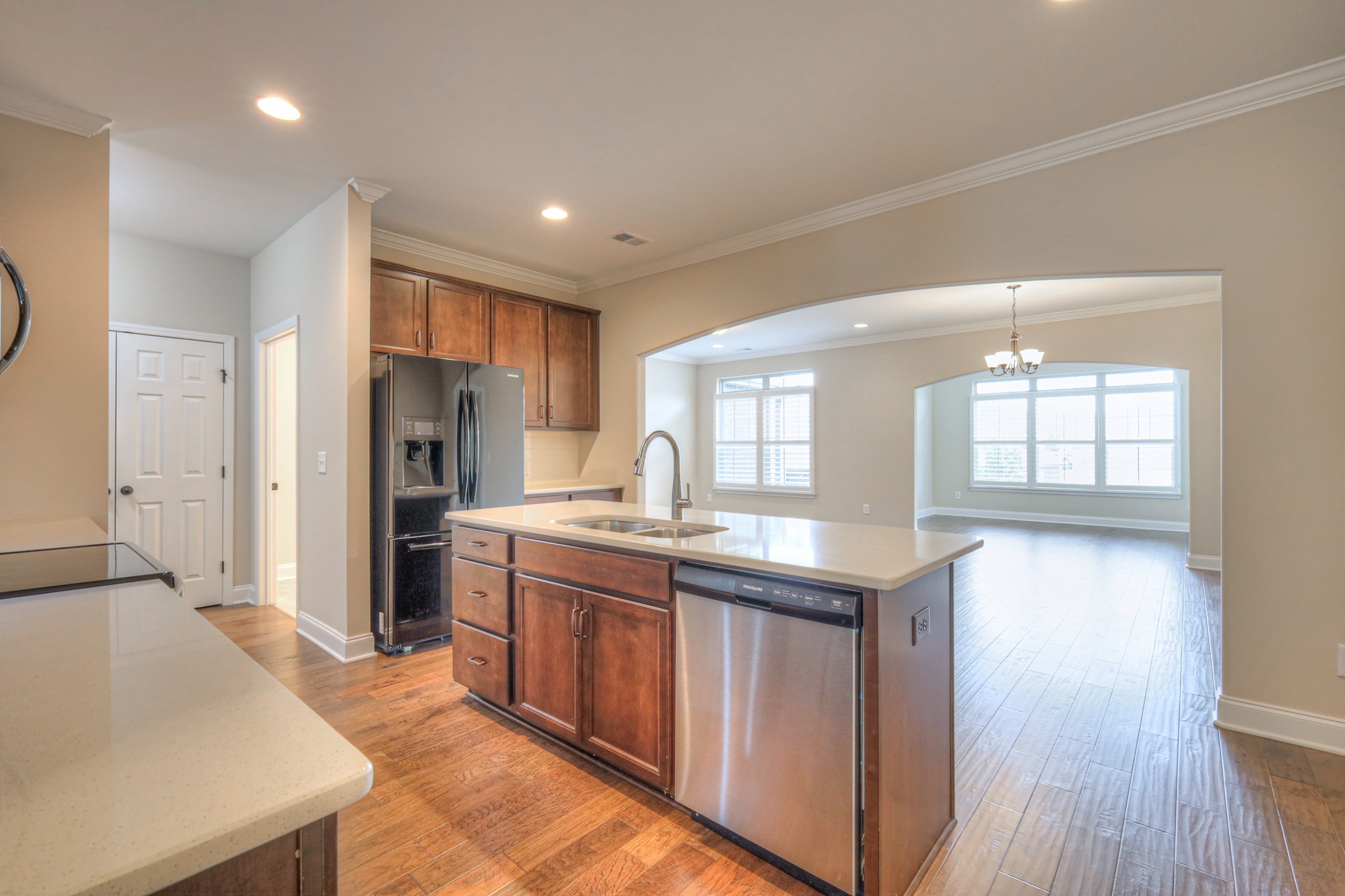 213 Vintage Way Lebanon, TN 37087 - Photo 5 of 33 a kitchen with stainless steel appliances granite countertop a refrigerator a sink dishwasher a stove and white countertops with wooden floor
