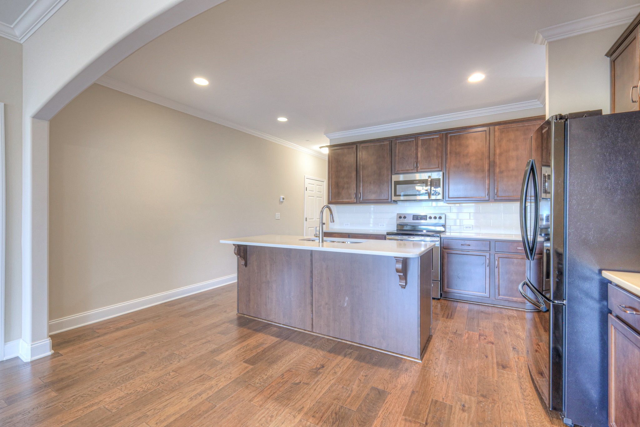 213 Vintage Way Lebanon, TN 37087 - Photo 8 of 33 a kitchen with wooden floors and refrigerator