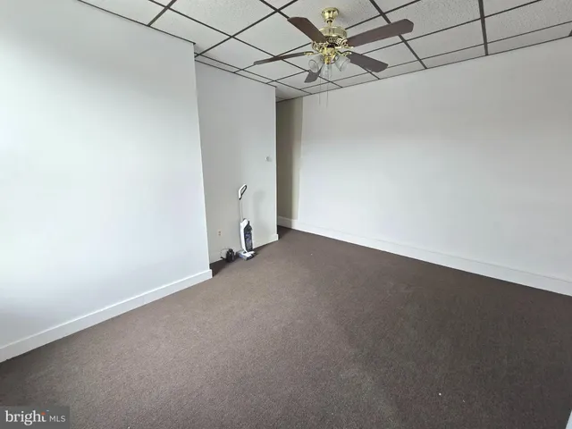 a view of a big room with a fan