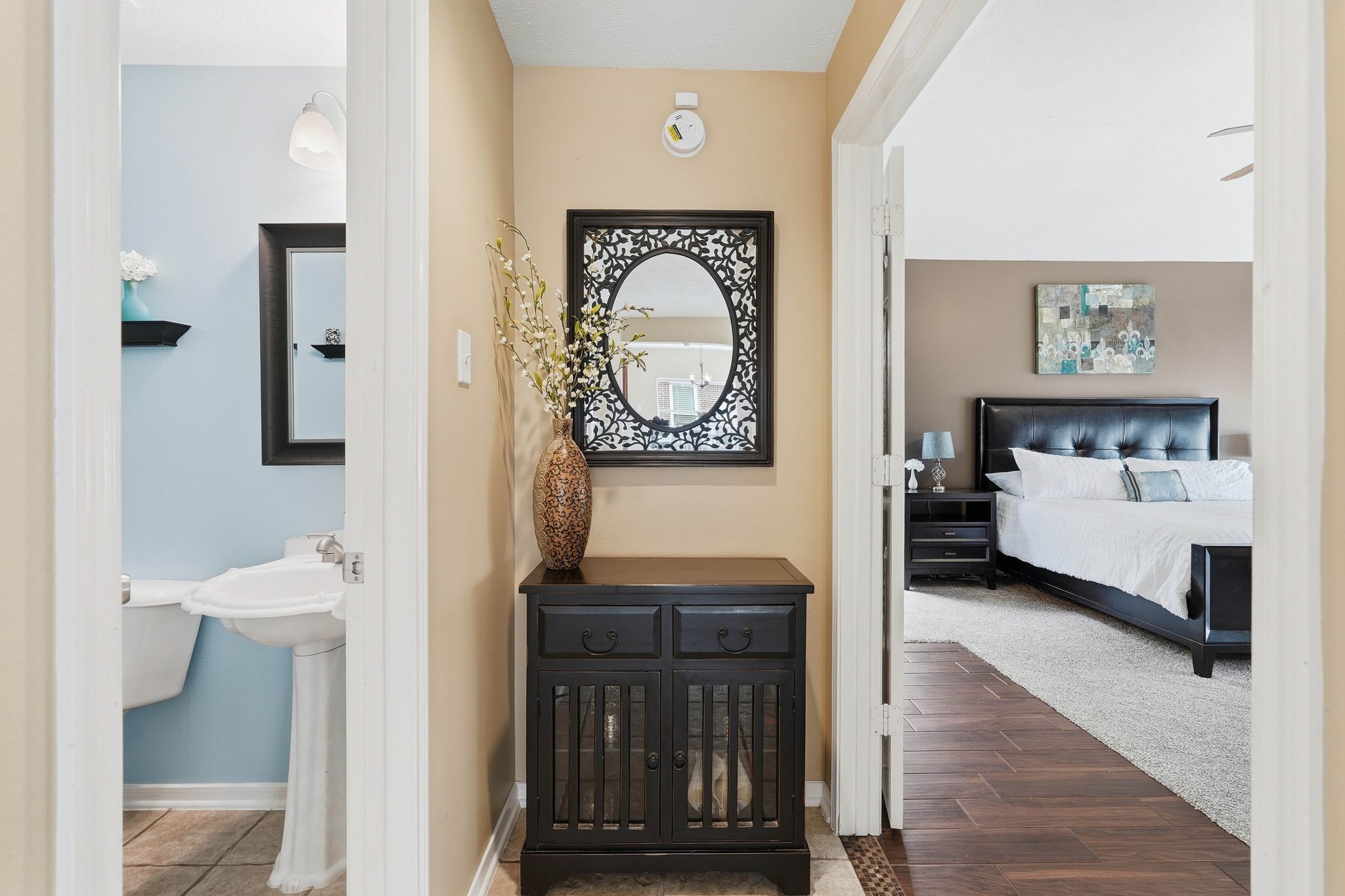 2515 Woodsboro Drive Spring, TX 77388 - Photo 27 of 44 Hallway leading to the downstairs powder room on the left and the primary bedroom on the right.