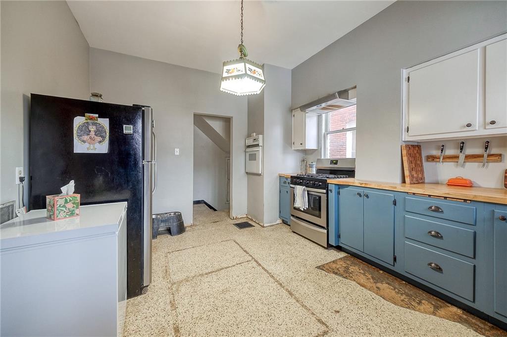 232 Chadwick Street Sewickley, PA 15143 - Photo 11 of 36 a kitchen with stainless steel appliances kitchen island granite countertop a refrigerator and a stove top oven