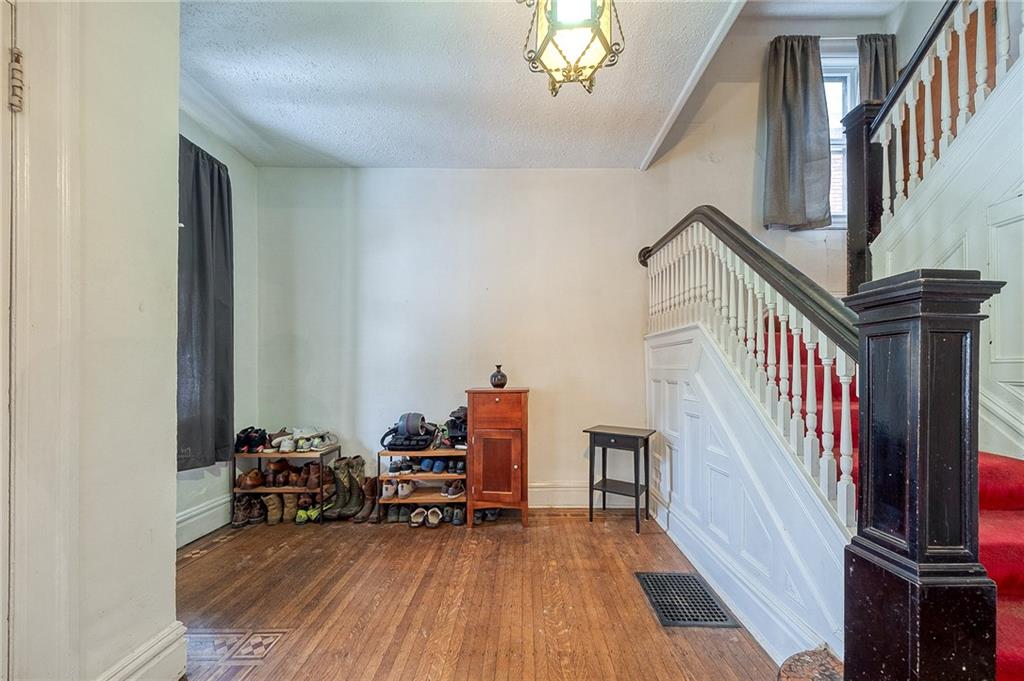 232 Chadwick Street Sewickley, PA 15143 - Photo 4 of 36 a view of a room with wooden floor and stairs