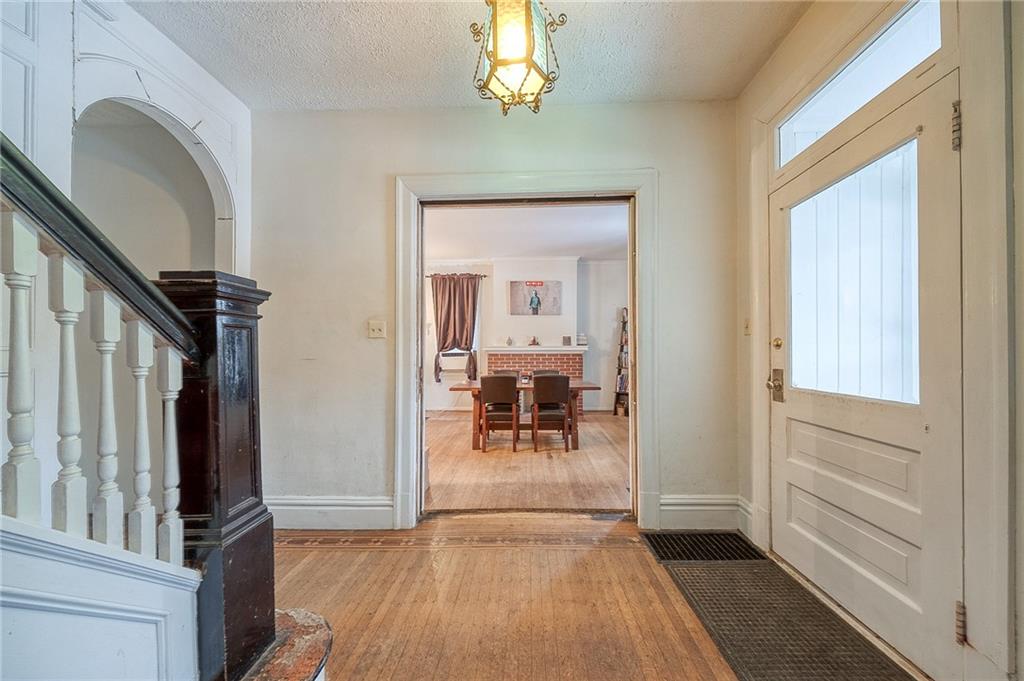 232 Chadwick Street Sewickley, PA 15143 - Photo 5 of 36 a view of a hallway view with wooden floor and staircase