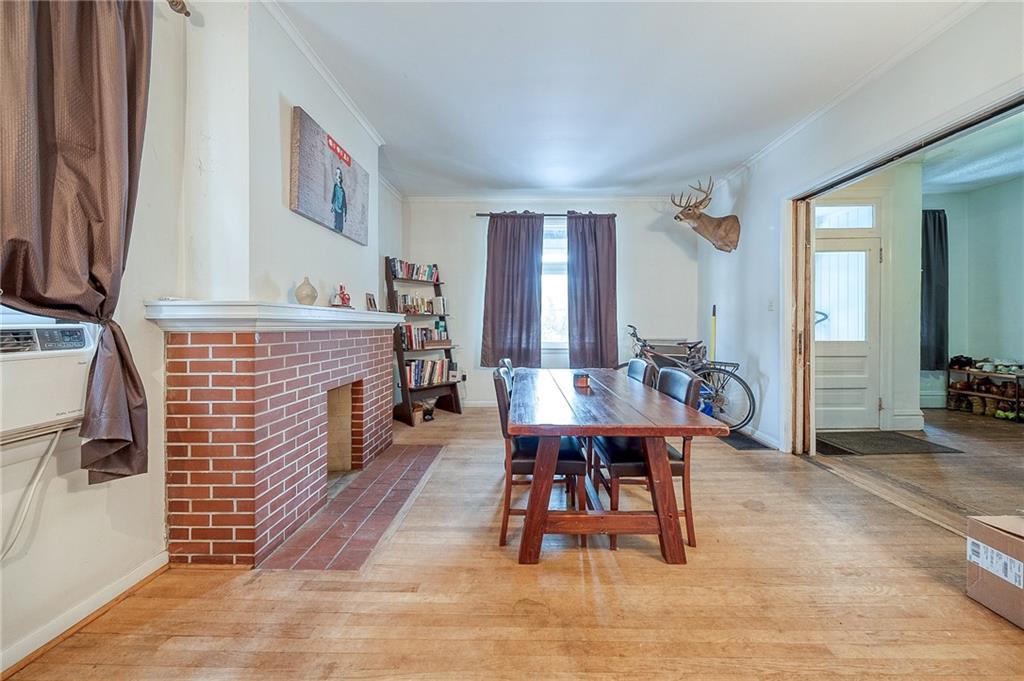 232 Chadwick Street Sewickley, PA 15143 - Photo 8 of 36 a dining room with furniture a fireplace and wooden floor