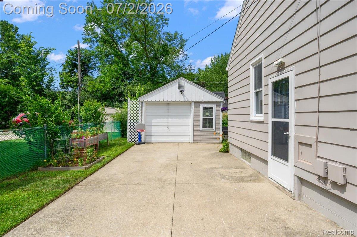 1706 Princeton Road Berkley, MI 48072 - Photo 44 of 49 Concrete driveway extending to a detached garage with a white panel door