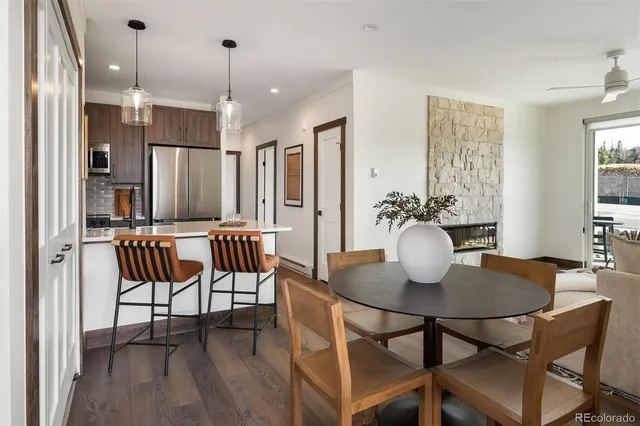 a dining room with furniture and wooden floor