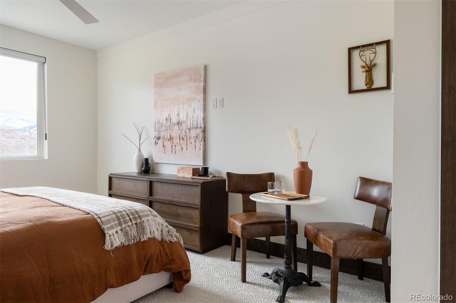 340 Sterling Loop, Unit 1 Fraser, CO 80442 - Photo 15 of 28 a bedroom with a bed and a table in it