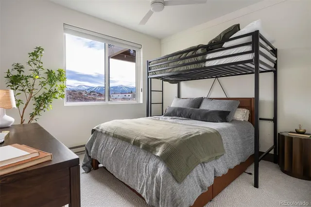 a bedroom with a bed and a mirror