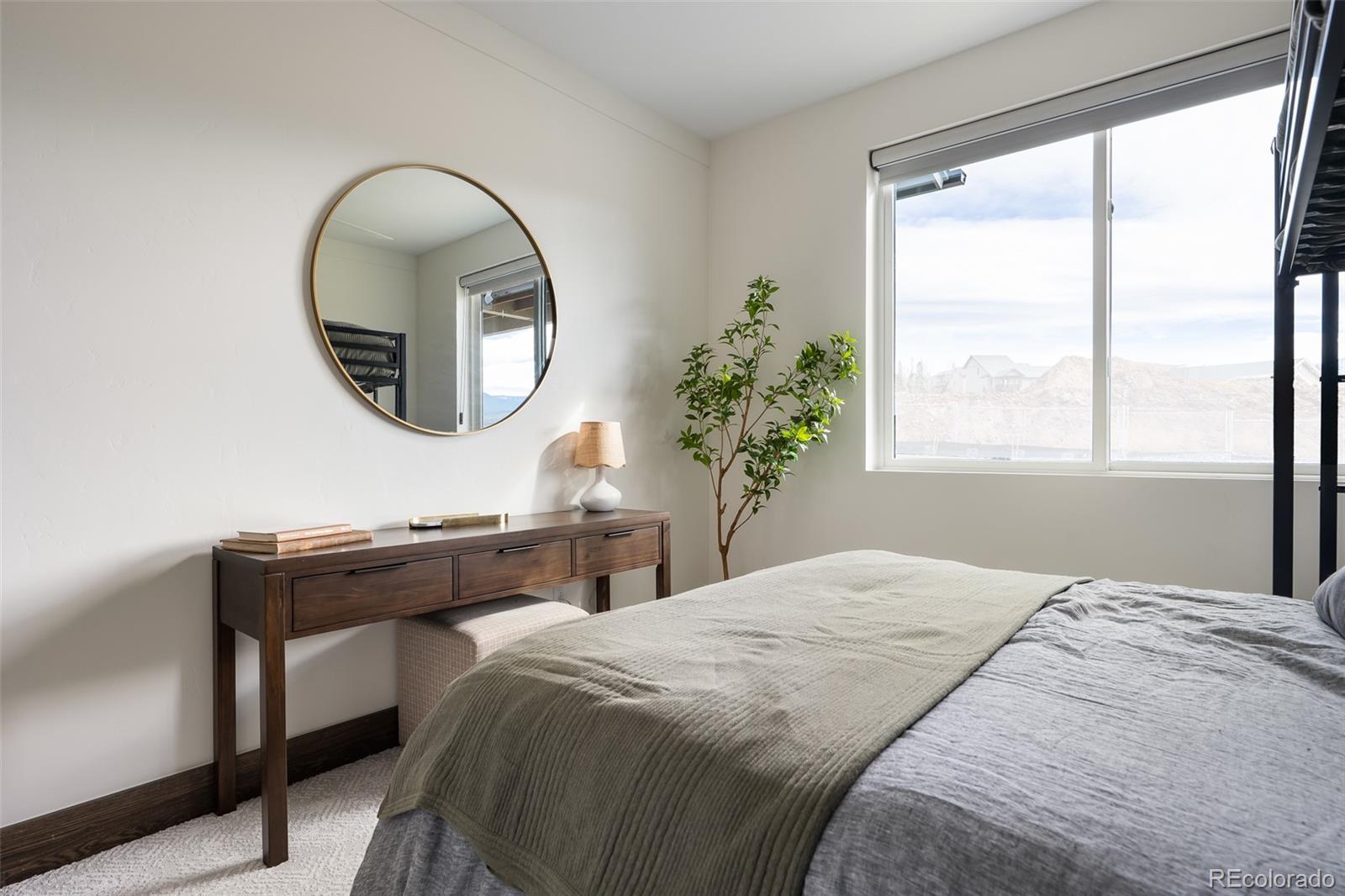 340 Sterling Loop, Unit 1 Fraser, CO 80442 - Photo 20 of 28 a bedroom with a bed and a mirror