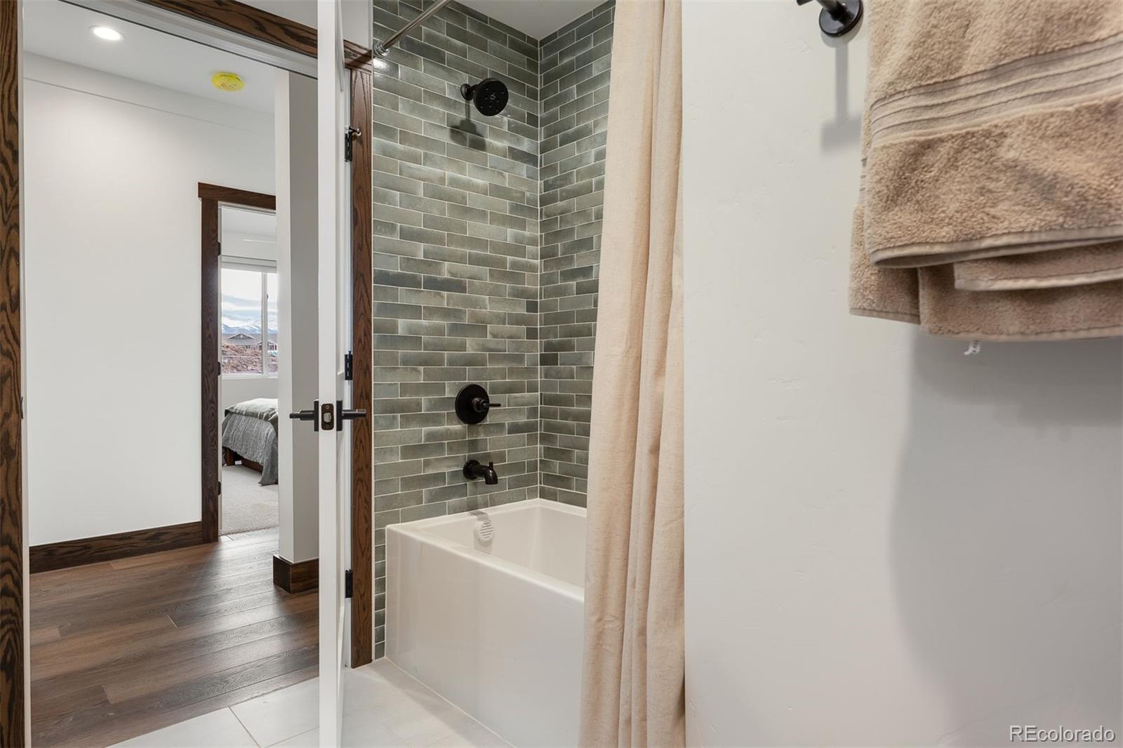 340 Sterling Loop, Unit 1 Fraser, CO 80442 - Photo 21 of 28 a bathroom with a bathtub and a shower