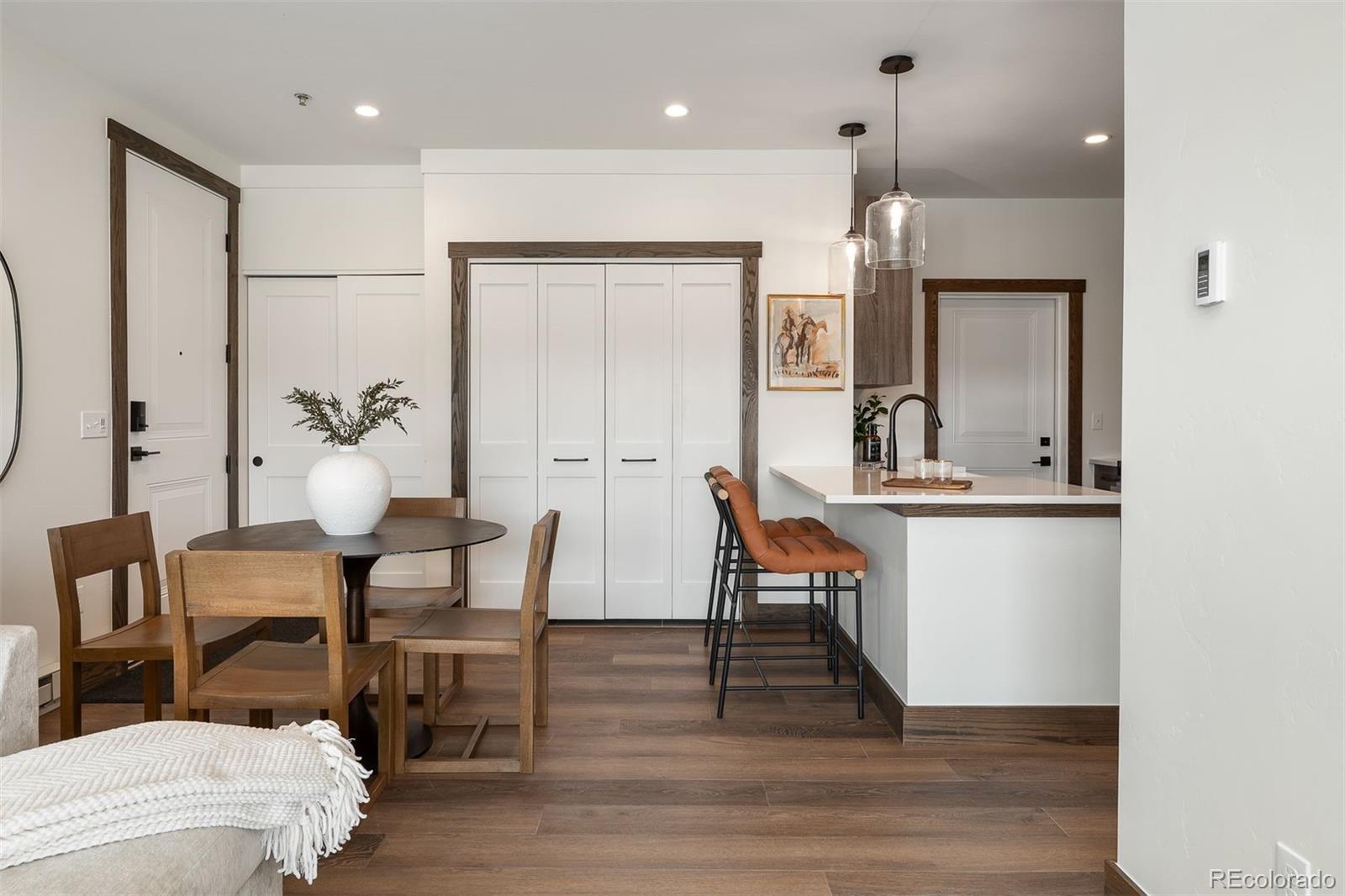 340 Sterling Loop, Unit 1 Fraser, CO 80442 - Photo 9 of 28 a dining room with furniture and wooden floor