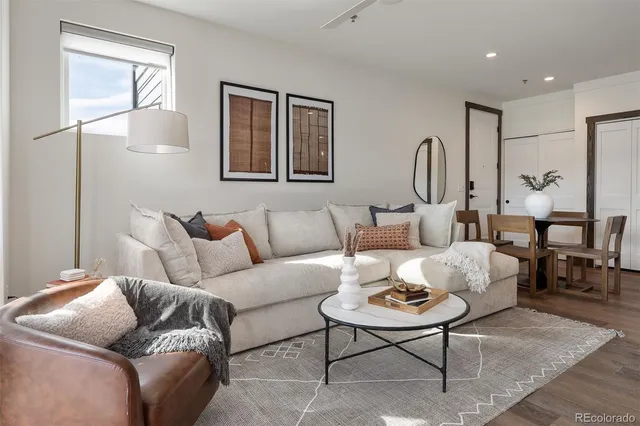 a living room with furniture potted plant and windows