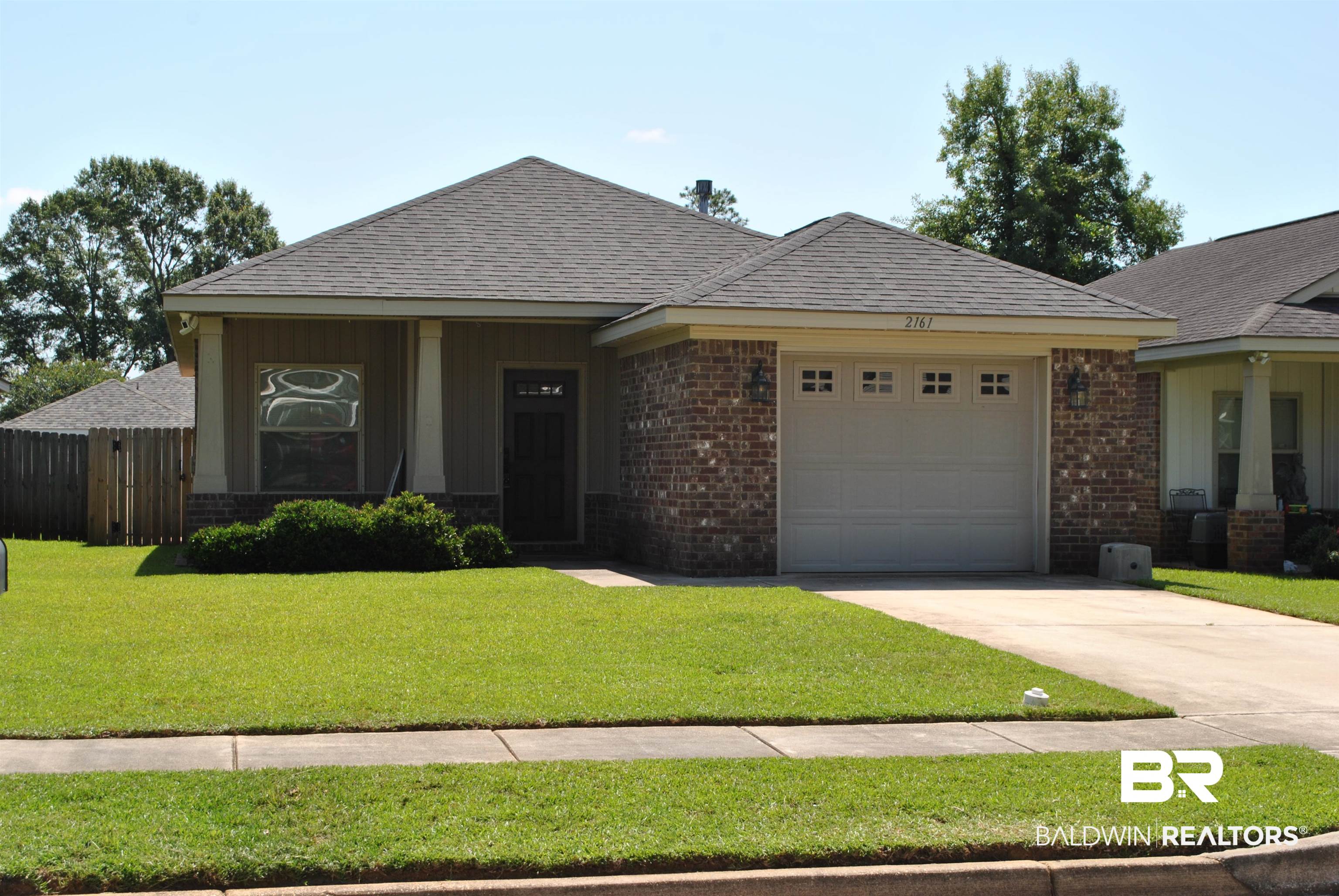 2161 Spring Grove West Mobile, AL 36695 - Photo 3 of 31 Ranch-style house featuring brick siding, an attached garage, concrete driveway, and roof with shingles