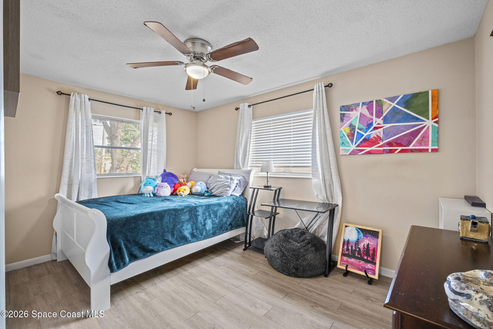 1088 Coronado Drive Rockledge, FL 32955 - Photo 18 of 23 a bedroom with a bed and wooden floor