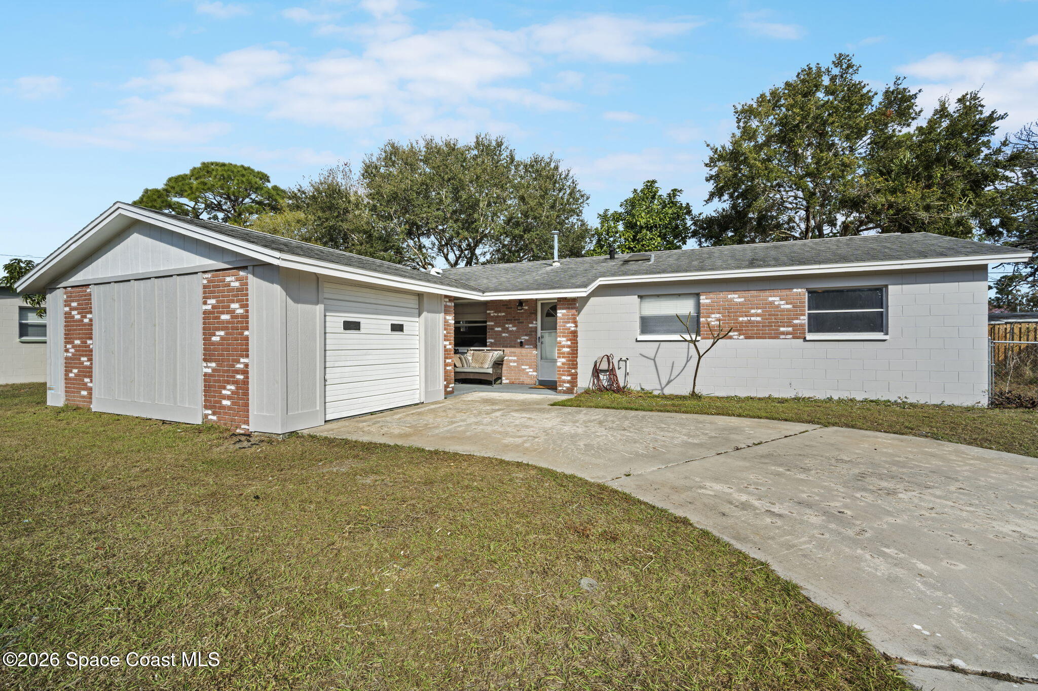 1088 Coronado Drive Rockledge, FL 32955 - Photo 2 of 23 a front view of a house with a yard and garage