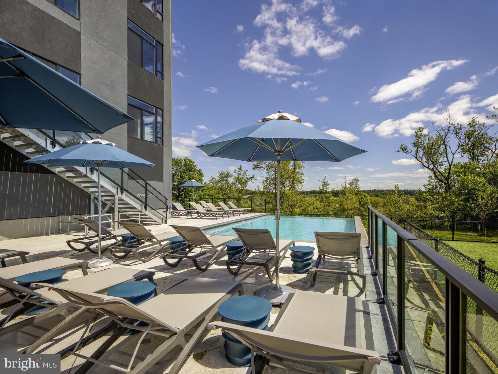 9 Presidential Boulevard, Unit 0B223 Bala Cynwyd, PA 19004 - Photo 17 of 20 a view of a patio with chairs and umbrella
