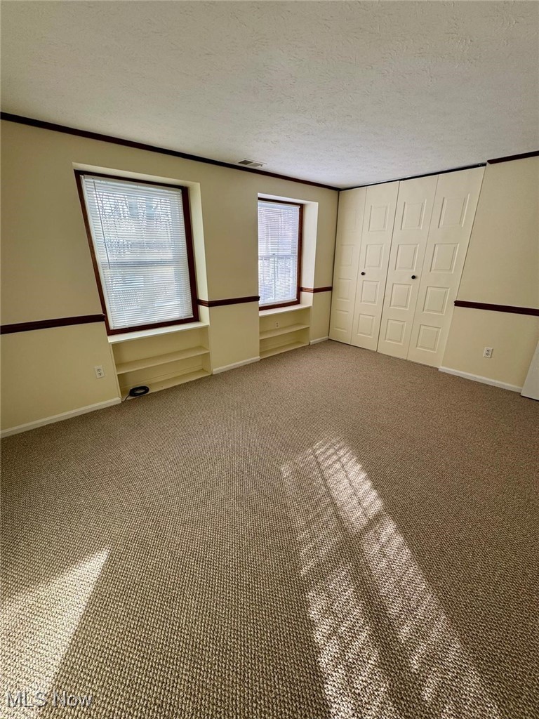 17073 Drake Road Strongsville, OH 44136 - Photo 38 of 50 Unfurnished bedroom featuring a textured ceiling, carpet floors, and a closet