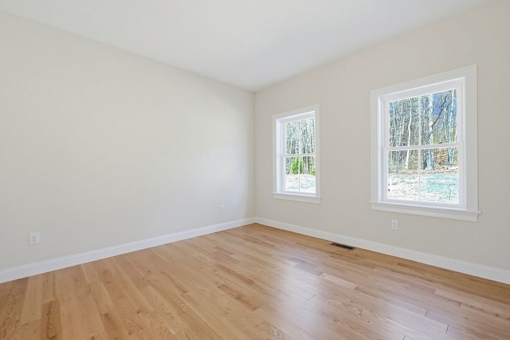 112 West Meadow Road Townsend, MA 01474 - Photo 13 of 38 an empty room with wooden floor and windows