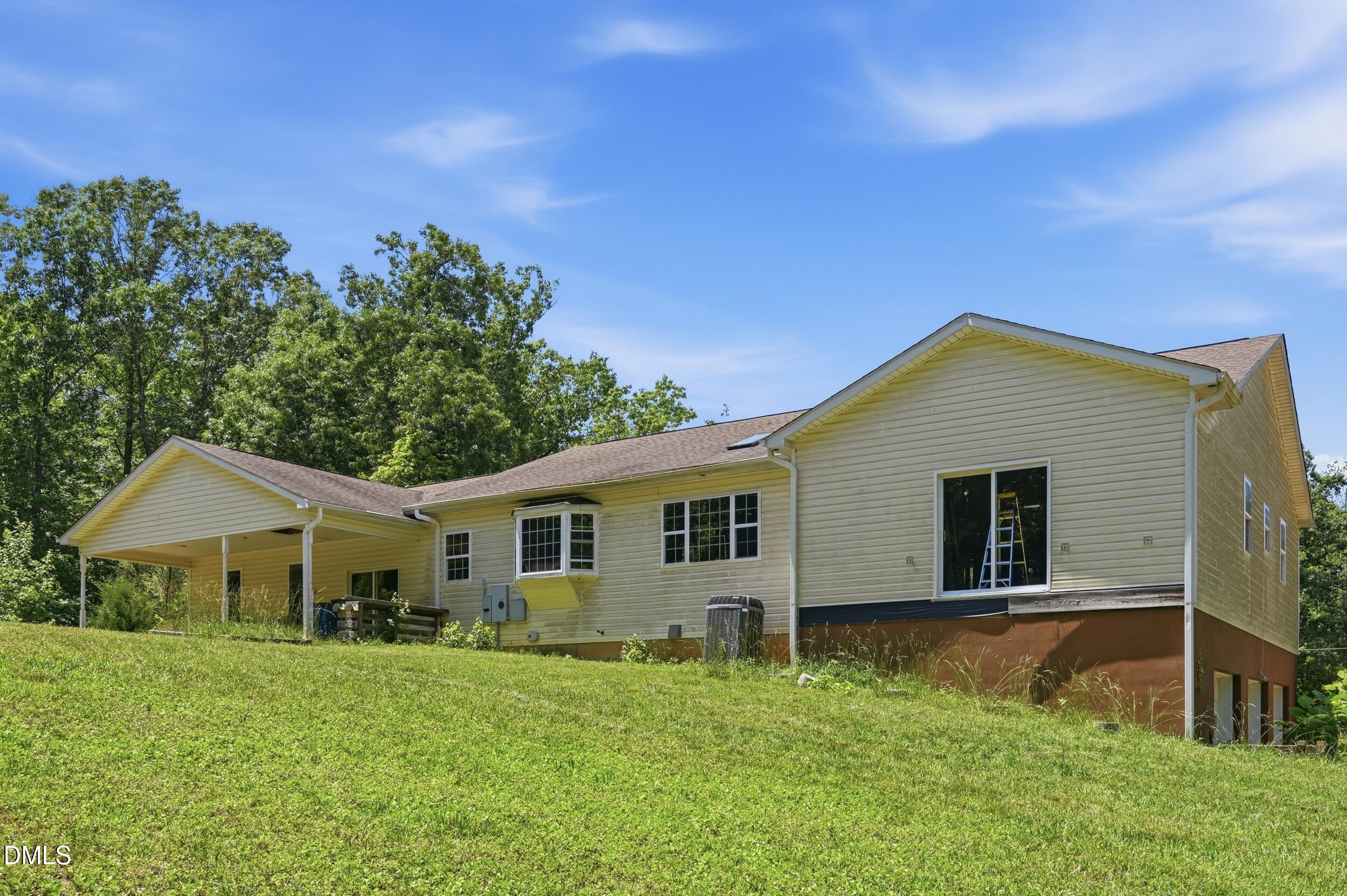 129 Shaman Drive Spring Hope, NC 27882 - Photo 28 of 43 a house with green field in front of it