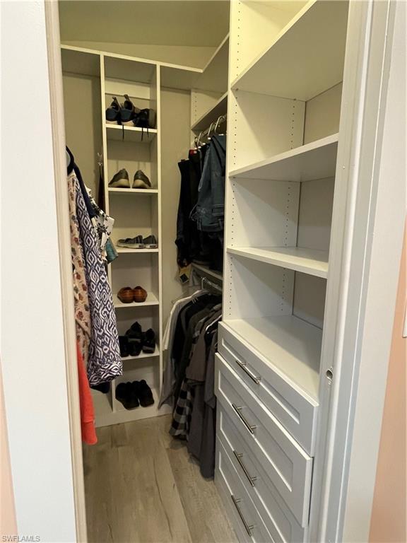 101 Oceans Boulevard, Unit 101 Naples, FL 34104 - Photo 11 of 14 a view of walk in closet with clothes and shoes