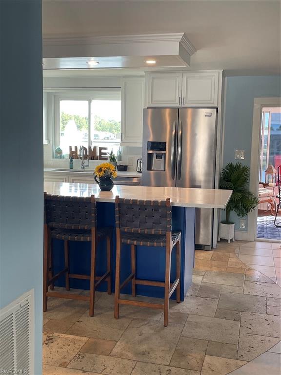 101 Oceans Boulevard, Unit 101 Naples, FL 34104 - Photo 5 of 14 a kitchen with granite countertop a refrigerator and a stove