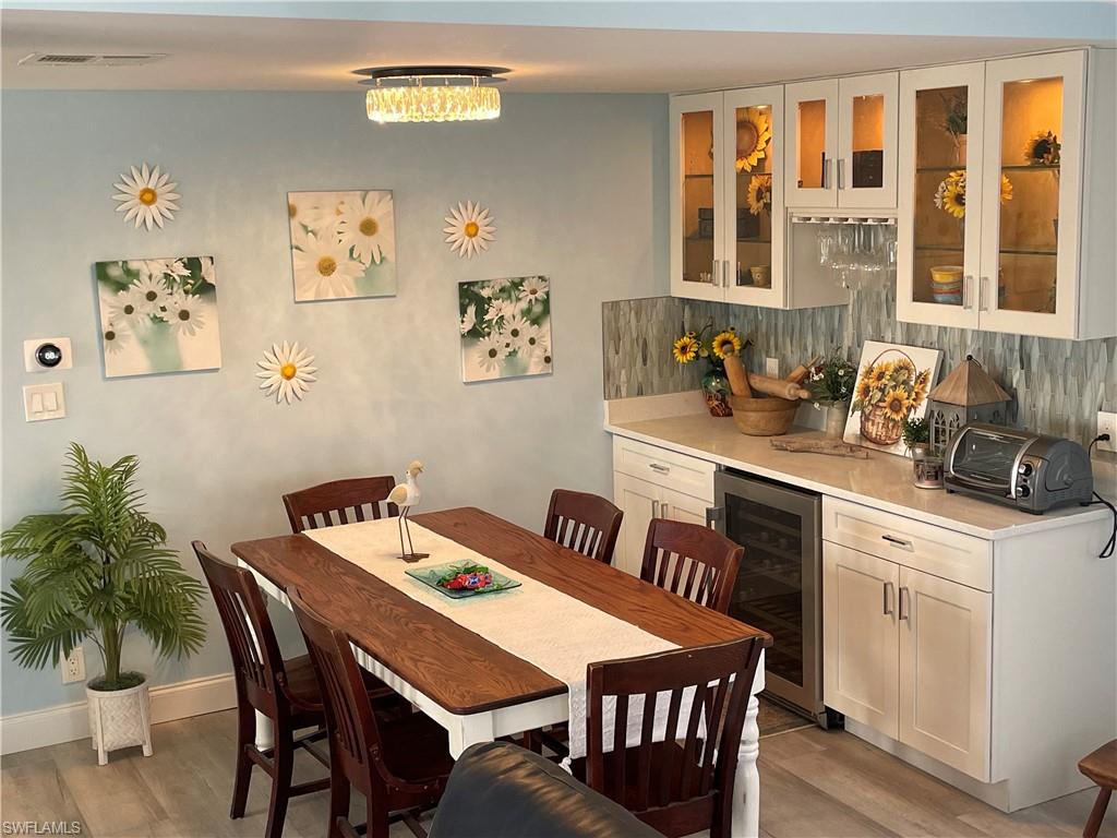 101 Oceans Boulevard, Unit 101 Naples, FL 34104 - Photo 6 of 14 a view of a dining room with furniture window and wooden floor