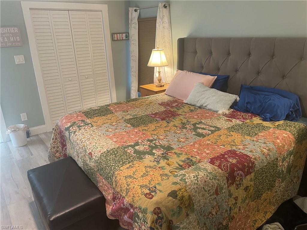 101 Oceans Boulevard, Unit 101 Naples, FL 34104 - Photo 9 of 14 a bedroom with a bed and a window